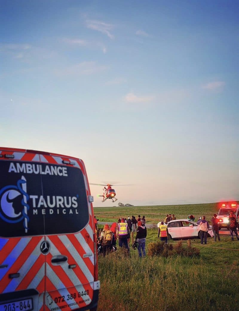 Air ambulance landing at a roadside collision at dusk